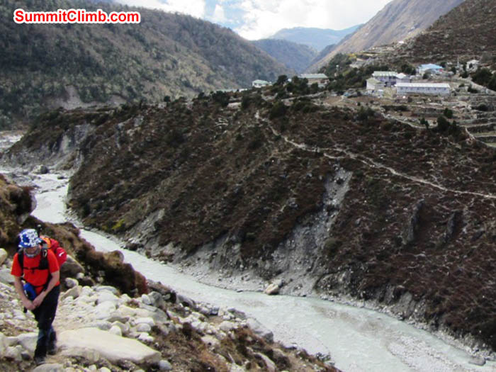Jim Barritt climbs the hill on the trail to Ama Dablam. Dudh Khosi river and Pangboche in the background. Photo Mark van 'T Hof.