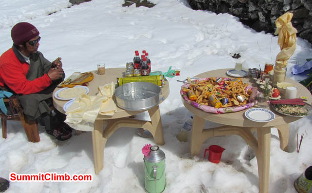 Lama Tashi and all of the gear one needs for a prayer ceremony in basecamp. Mark van 't Hof Photo.