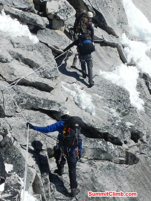Saz, Maggie, and Tenji climbing the granite slabs below the white tower. Mark van 't Hof Photo.
