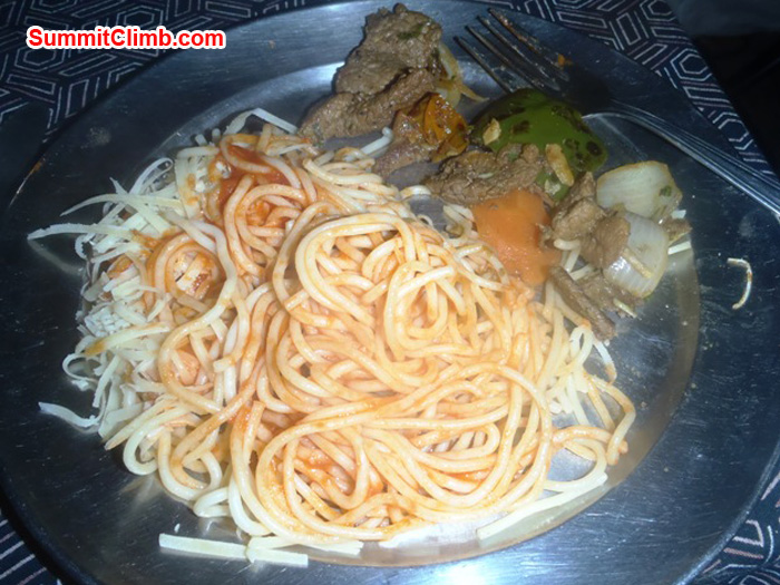 Delicious spaghetti dinner prepared by our skillful cooks at Kote camp. Pasta with freshly grated cheese, fresh spinach, sauteed onions and grillled steak. Photo by Andrew Davis
