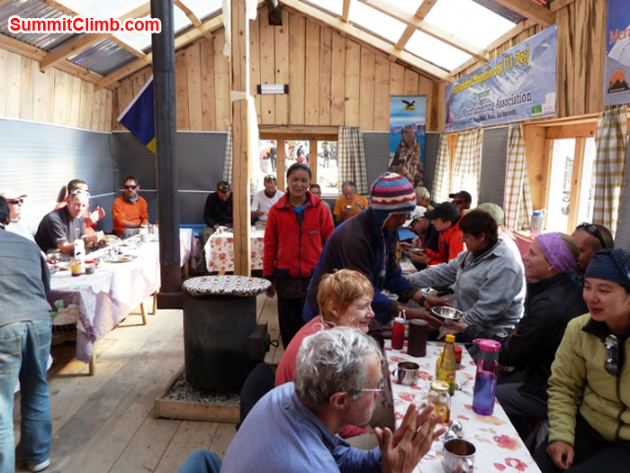 Team relaxes and enjoys afternoon sun in the sunny dining room at Kare Village Hotel. Photo by Andrew Davis.