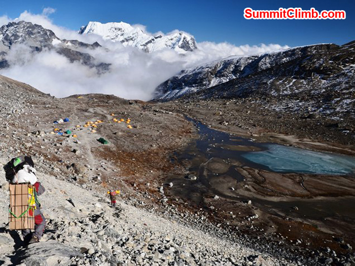 A porter carrying eggs and his personal bags down the trail to our mera peak basecamp, located on the shores of Naulekh Lake. Photo by Michael Moritz.