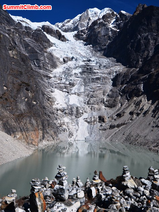 Stone prayer towers above Tagnag Lake with Tagnag Glacier in the background. Photo by Michael Moritz.