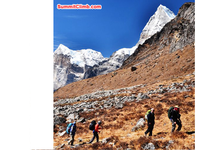 Team walks to Kare Village, Triputi Peaks in the background. Photo by Michael Moritz.