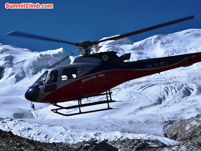 Heli comes in for a landing to pick up an exhausted climber. Photo by Michael Moritz.