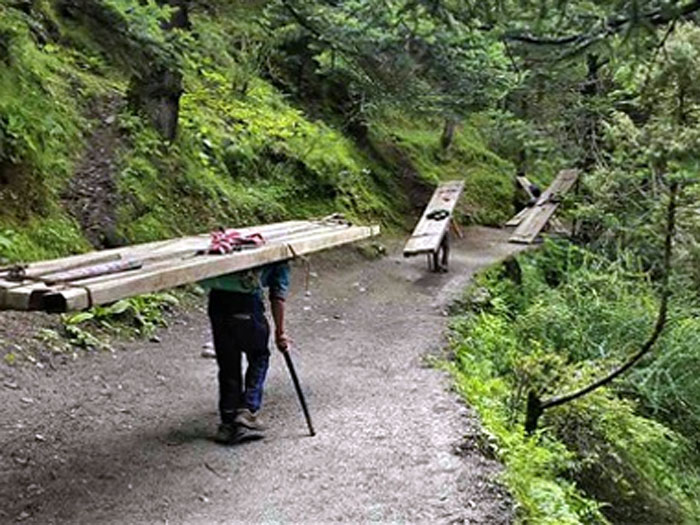poerters carrying wood