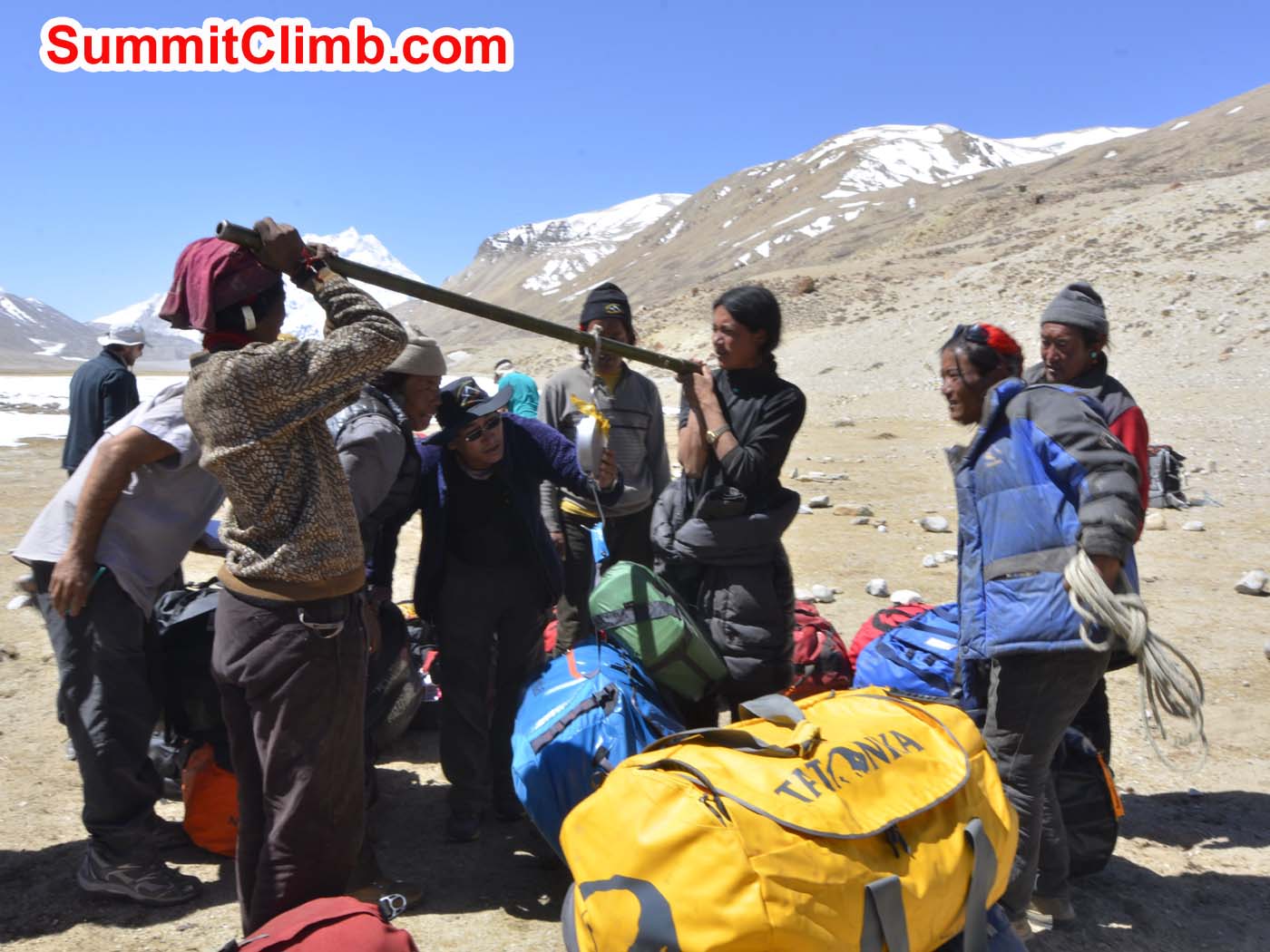 Tibetan yak drivers weighing loads at Cho Oyu's 'chinese' basecamp. Dmitri Nichiporov photo