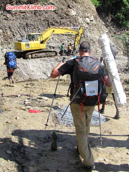 steve walks through the landslide areas with porters and an excavator. Troy Bacon Photo