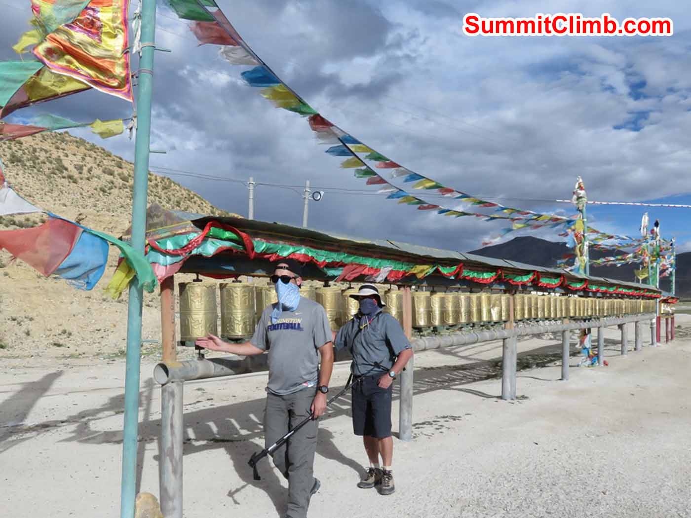 Stu Frink and Jim Bingaman spinning prayer wheels in Tingri by Kaley Erickson.