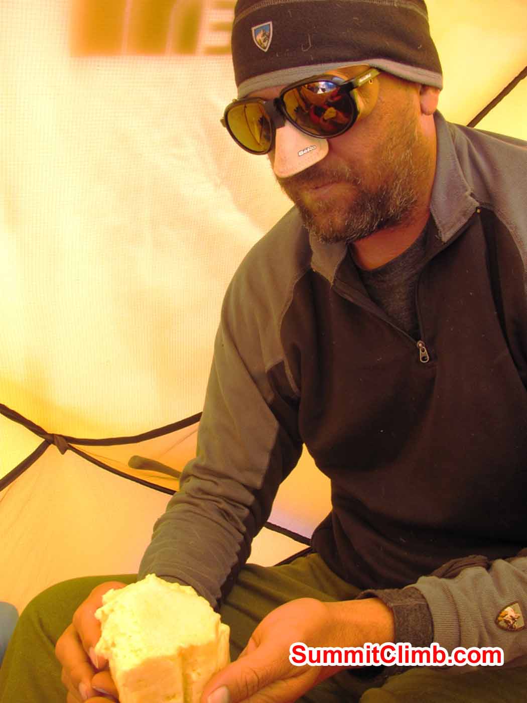 Steve enjoys a yummy bite of Yak cheese in Camp 2. Troy Bacon Photo