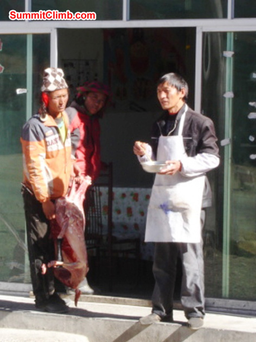 A nomad sells a sheep to a restarateur in Tingri. James Grieve Photo