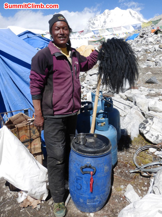 Chimi, our Tibetan cook, shows off a Yak's tail in basecamp. Juergen Landmann Photo
