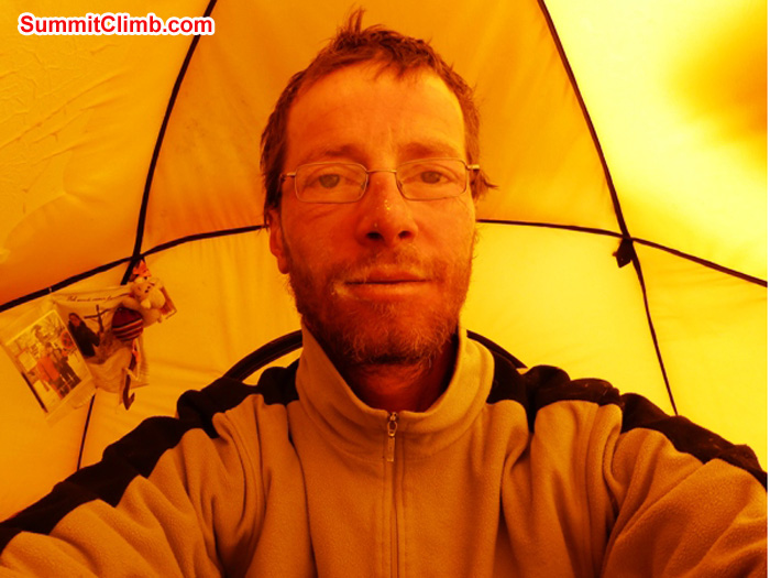 Juergen Landmann back home in ABC in his personal sleeping tent. Photos of his family on the wall over his shoulder. Juergen Landmann Photo