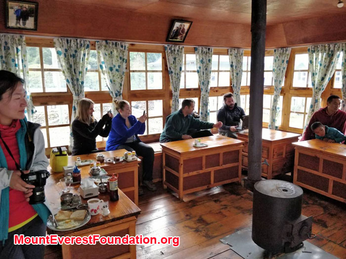 Team and young monks are in tea house