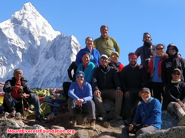 team members with mountain