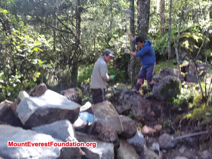 worker preparing stone for deboche