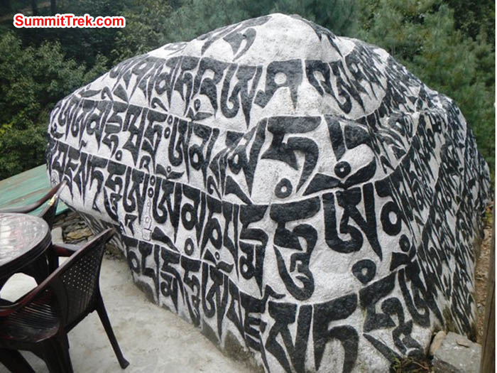 Carved prayer stone beside a table and chair along the Everest Basecamp Trek. Sangeeta Sindhi Photo