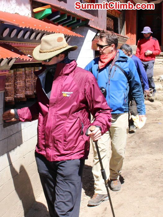 Mike, Scott, Lakpa and Carlos spinning prayer wheels at Pangboche Gompa. Sam Chappatte Photo