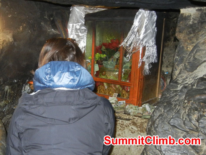 Mia inside cave at Ancient Rongbuk Monestery asking Mt Chomolungma for safe passage - Photo Scott Patch