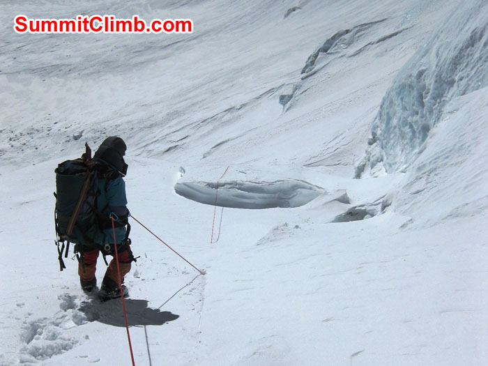 Sherpa pulling fixed line above fresh snow on North Col - Photo Mia Graeffe