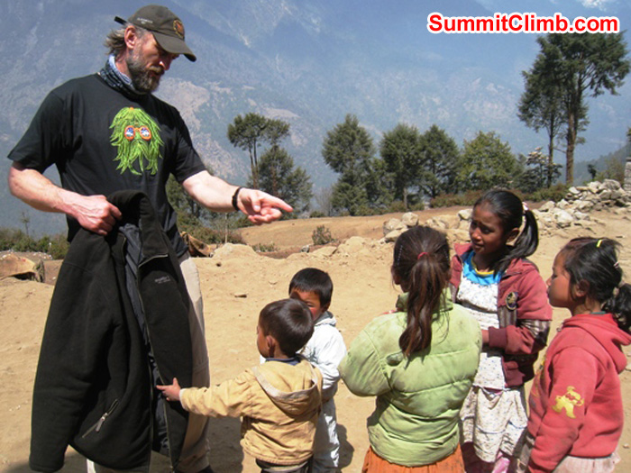 Adam Dixon conducts an impromptu class for local kids at Lukla. Scott Smith Photo.