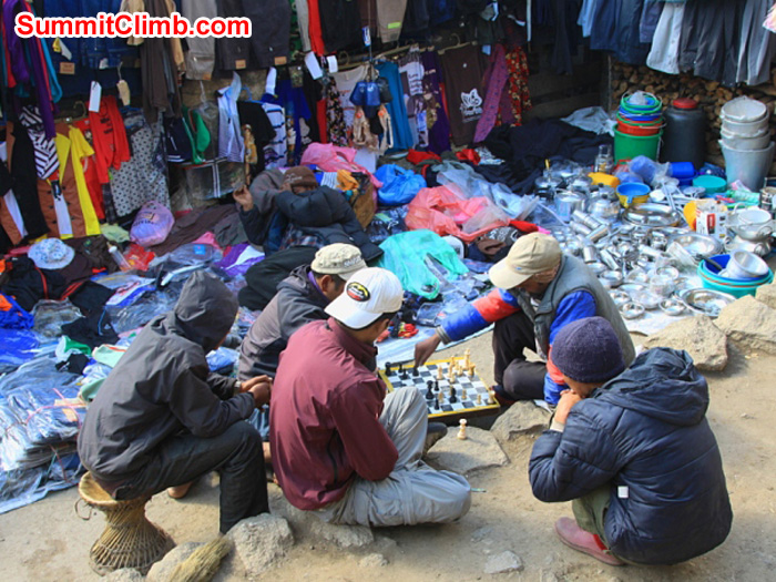 Playing chess in Namche Bazaar Saturday market. Monika Witkowska Photo. Playing chess in Namche Bazaar Saturday market. Monika Witkowska Photo.