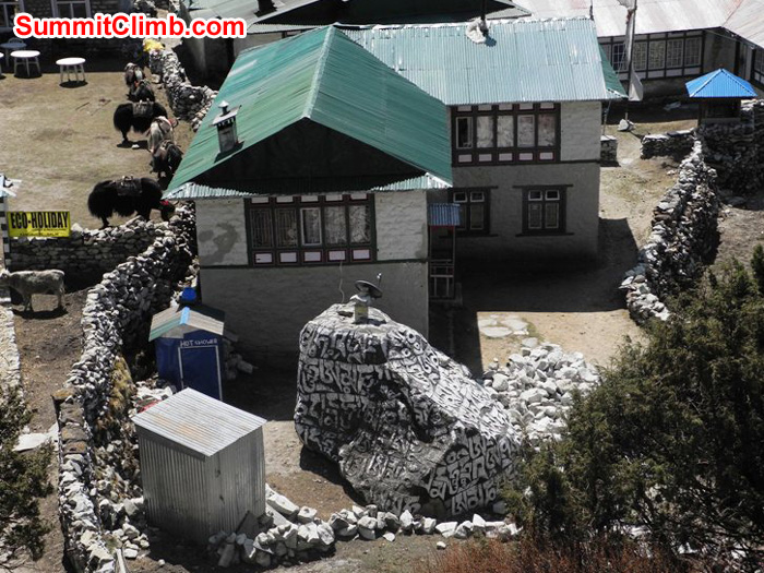 Pangboche village teahouse surrounded by stone walls with a large carved prayer stone in the garden. Violetta Pontinen Photo.