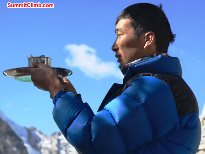 Pasang Sherpa presents an offering during the basecamp blessing ceremony. Monika Witkowska Photo. Pasang Sherpa presents an offering during the basecamp blessing ceremony. Monika Witkowska Photo.
