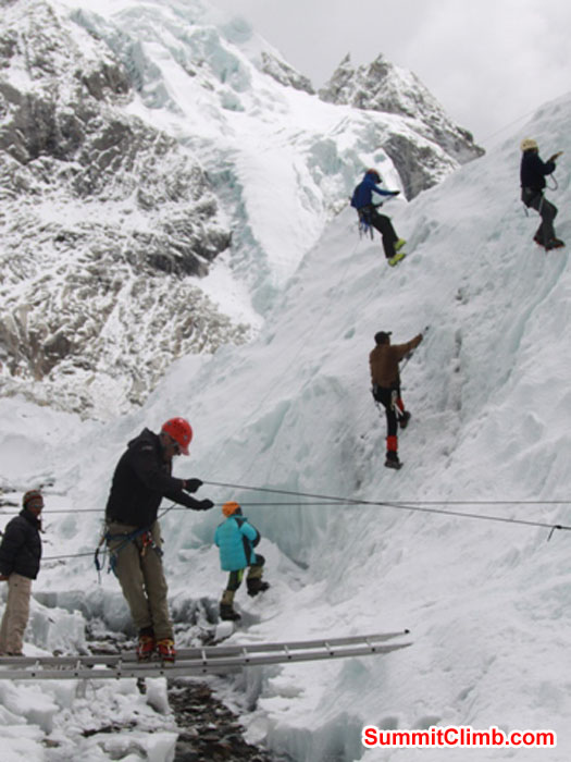 Team practices ladder crossings and ice climbing ascending and descending in the Khumbu Glacier near basecamp. Monika Witkowska Photo. Team practices ladder crossings and ice climbing ascending and descending in the Khumbu Glacier near basecamp. Monika Witkowska Photo.