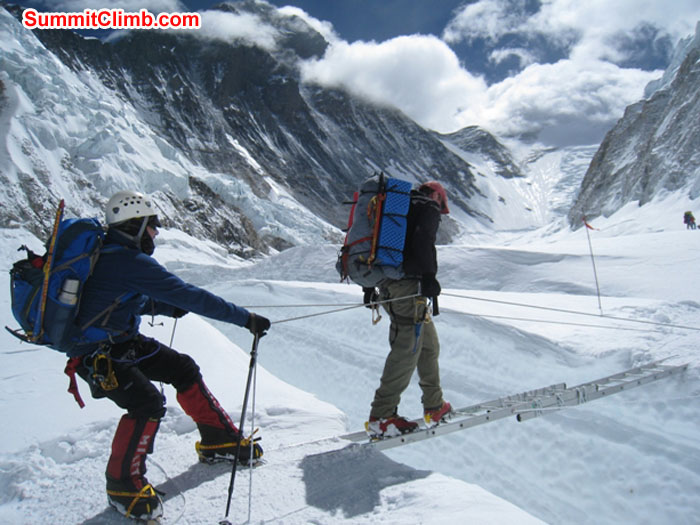 Kieran Lally holds the ropes for Dan Mazur Crossing a Crevasse in the Western Cwm. Photo by Scott Smith. Kieran Lally holds the ropes for Dan Mazur Crossing a Crevasse in the Western Cwm. Photo by Scott Smith.