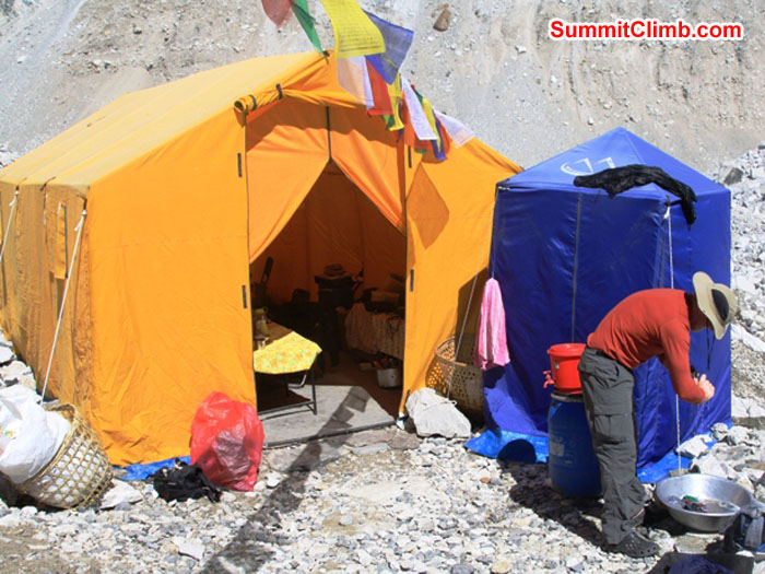 Basecamp Life. Scott Smith doing his laundry in front of the dining tent. Monika Witkowska Photo