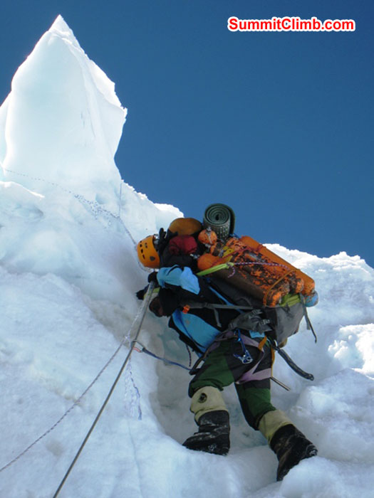 Jangbu Sherpa carrying 17 empty oxygen bottles down to basecamp. Scott Smith Photo.JPG