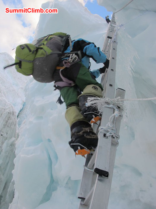 Jangbu Sherpa climbs the vertical triple section ladder which later collapsed. Thankfully no one was injured. Monika Witkowska Photo.