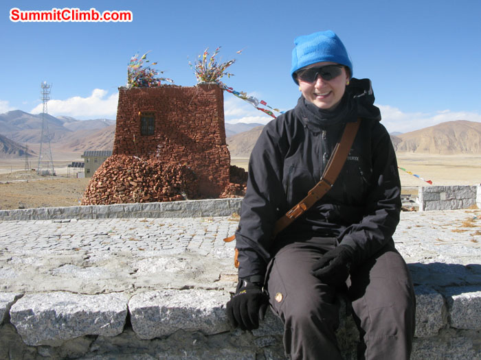 Rikke at Tingri behind Fortified tower reconstructed from the ruined Tingri fort. This is now Tingri’s main temple