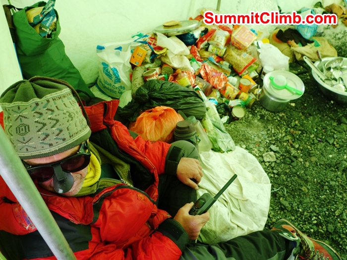 Dan speaking on satphone in camp 2 kitchen. Franz Ruehrlinger Photo