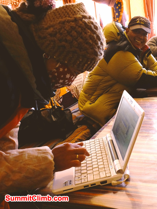 Dolma shows us how Tibetans use computers while Murari looks on