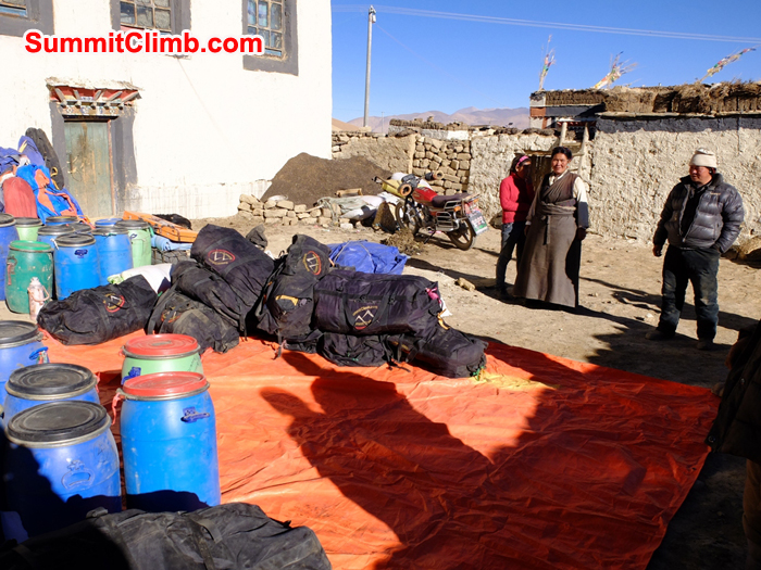 Getting started on checking the gear in our Everest storeroom. Large pile of SummitClimb duffle bags and blue drums