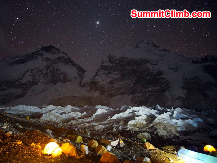 Star and moons are in the sky and lights are up inside tents