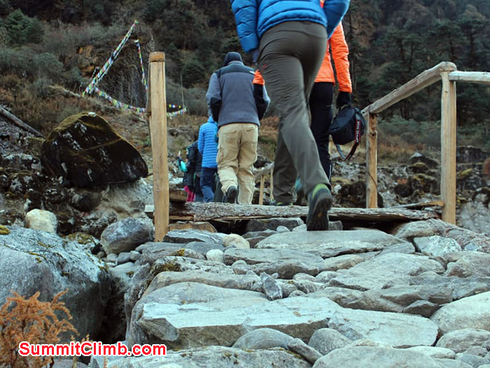 team members crossing bridge