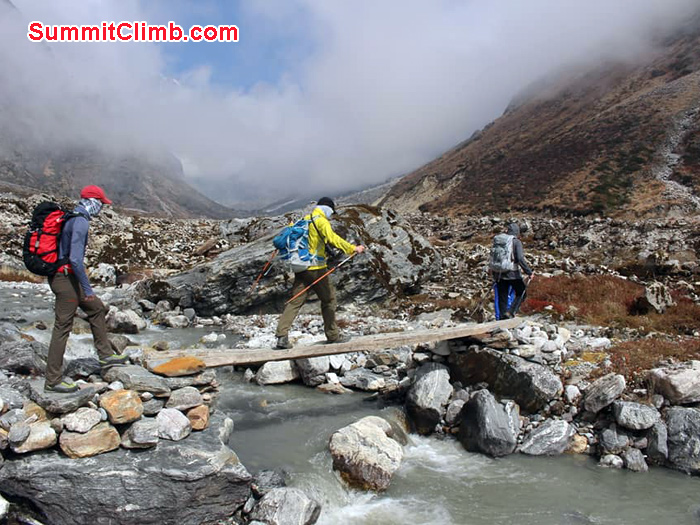 team members crossing bridge