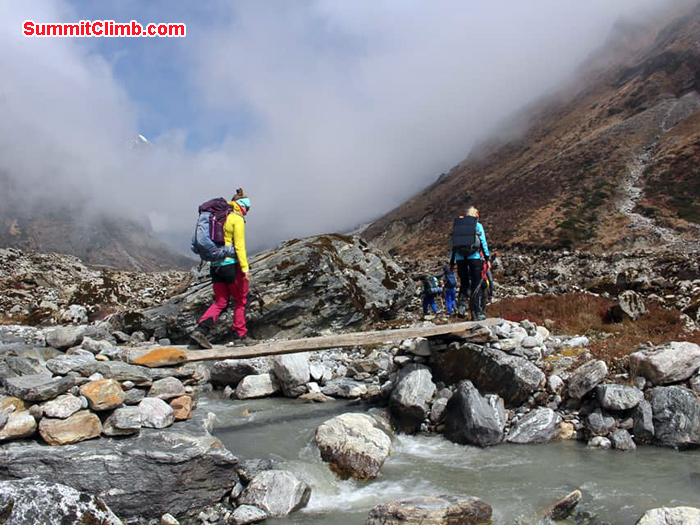 team members crossing bridge
