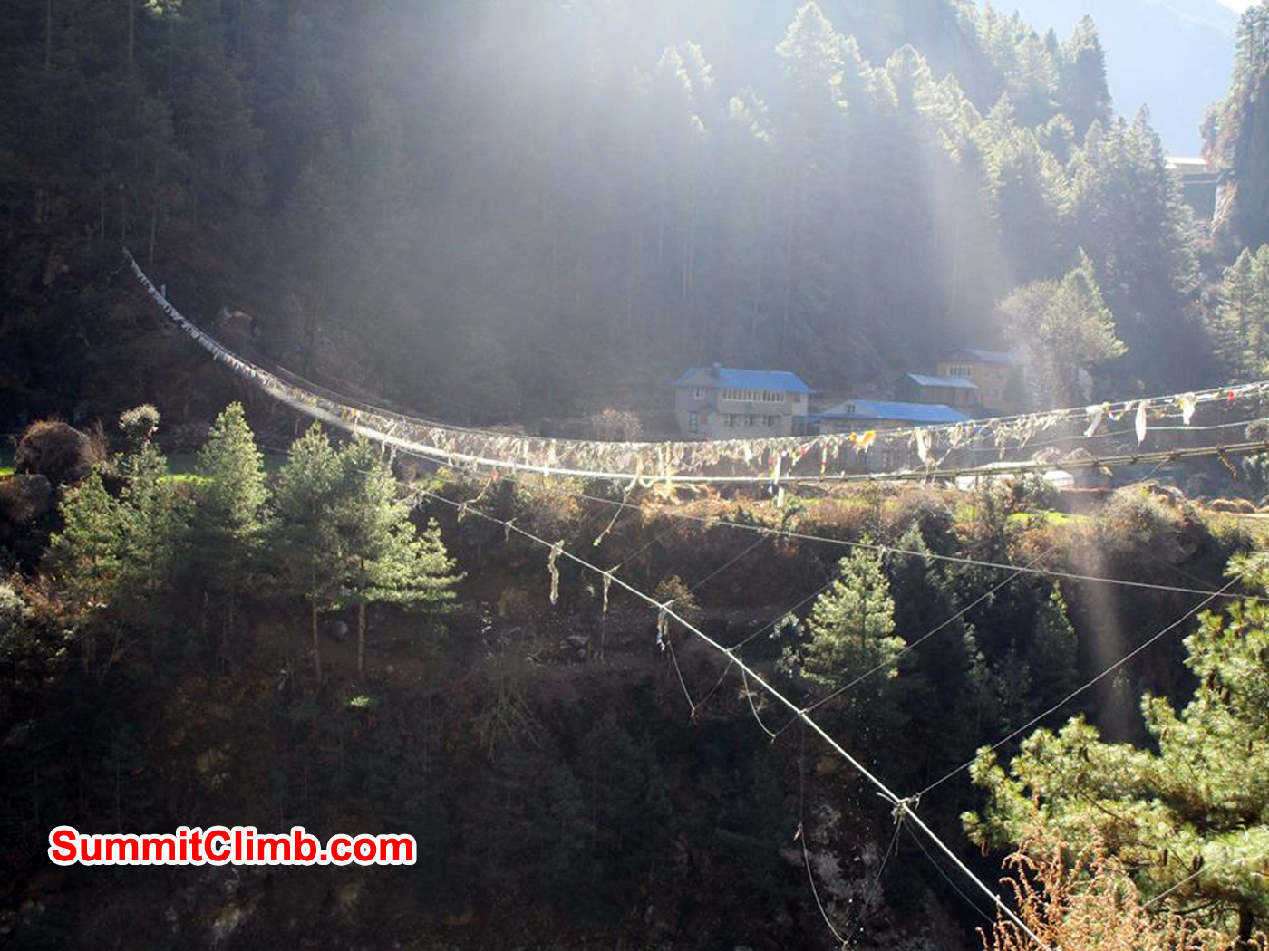 Suspension bridge in the sun. Prayer flags are hung everywhere and the wind is supposed to carry the prayers around the world. Photo Meryl Lipman