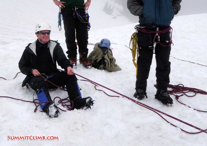 Randy works on his hip-belay technique as he helps a fellow participant climb up the slope (Anna Moll).