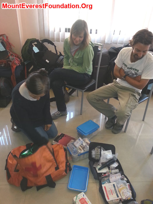 Marie (France), Daniela (Canada), and Jeremy (Australia) sorting medicines for the service trek. Photo by Deha Shrestha