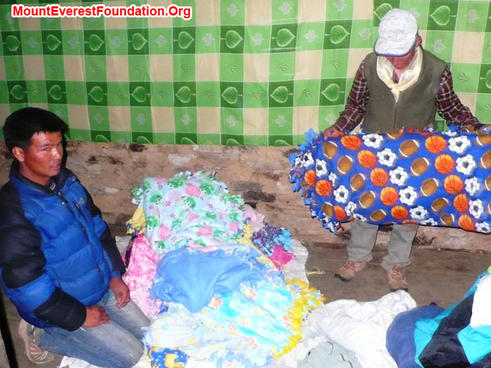 Nawang and Jangbu Sherpa unpacking donations from Shaker Juniour High at the Patale Health Post