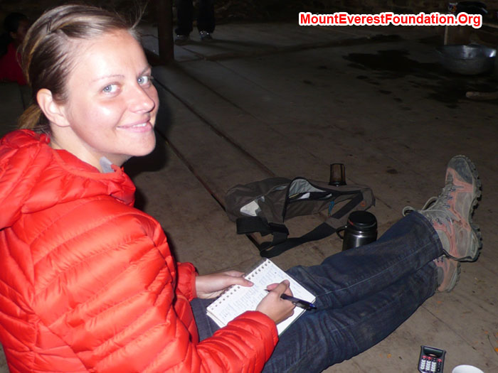 Daniela Milea, from Romania, calculates the gratuities inher 'office' at the Patale Health Post