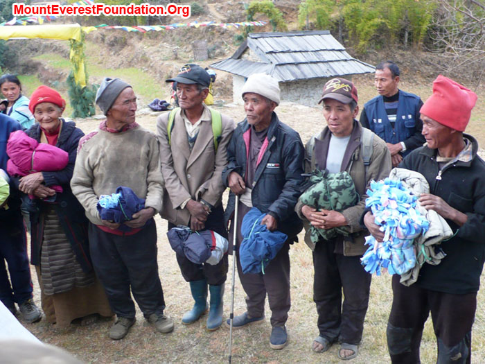 Elderly members of the village receiveing generous donatins from Anne Kates, Wolfgang Nicola, Johan Frankelius, Carmen McMillan Nelon, the Juniper Foundation, and Shaker Juniour High.