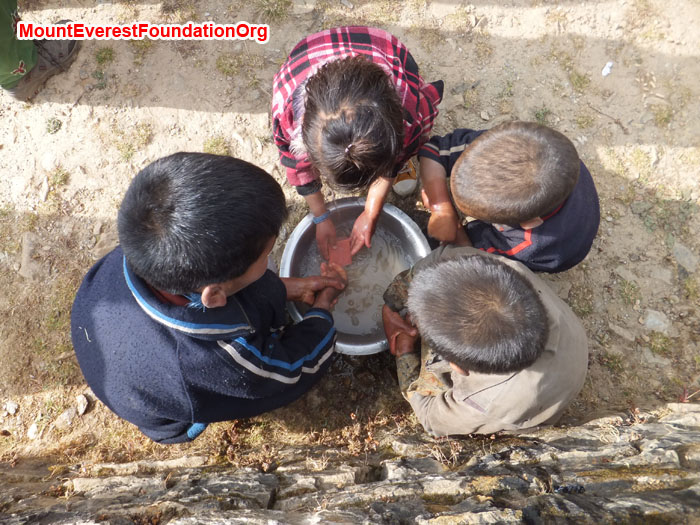 Students from Dhorkharka School practice washing their hands to prevent from germs. Photo by Dan Mazur