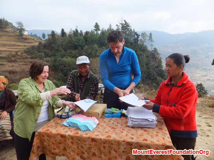 Anne Kates, Jangbu Sherpa, Wolfgang Nicola, and Yangjie Sherpa organizing school supplies before distributing to all local students. Photo by Dan Mazur